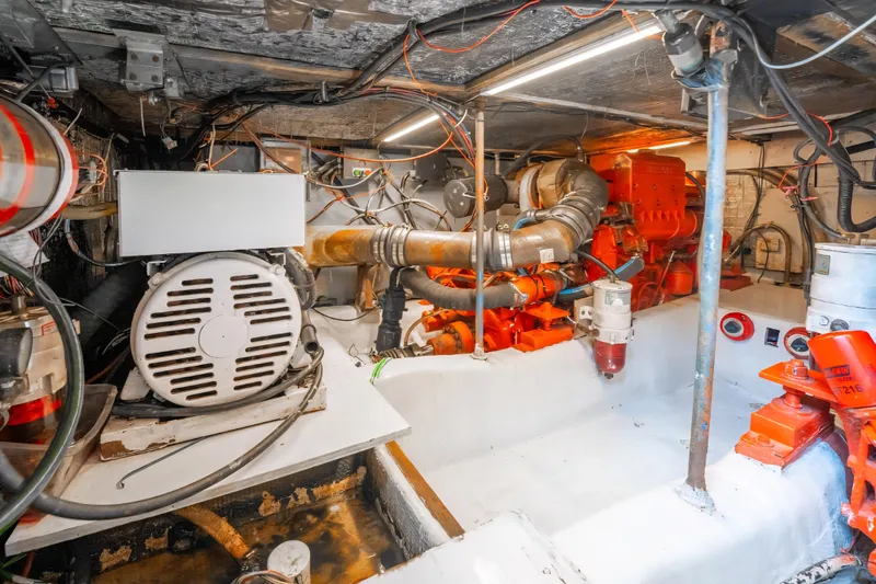 Slide: The Image of Engine room of 1988 Ocean Yachts 48 Super Sport, showcasing mechanical components and wiring. - 36