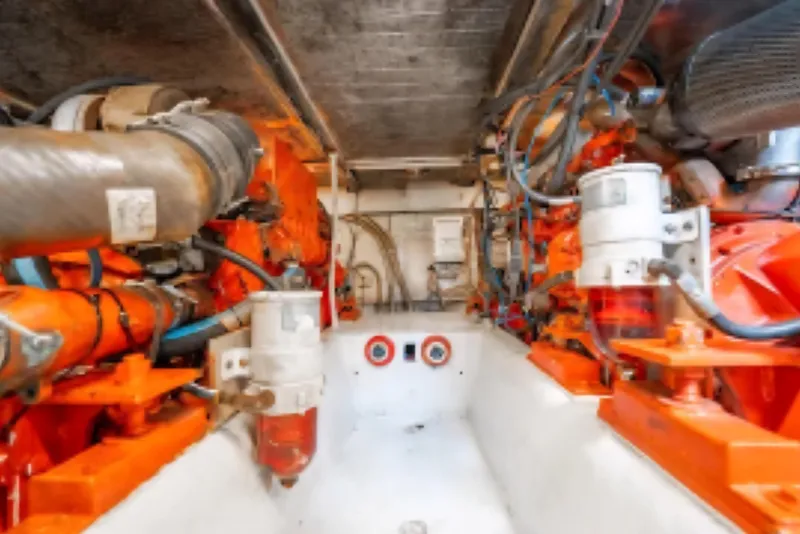 Slide: The Image of Engine room of 1988 Ocean Yachts 48 Super Sport, showcasing vibrant orange machinery. - 37