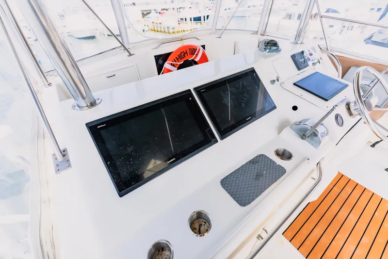 Slide: The Image of 1988 Ocean Yachts 48 Super Sport helm with dual screens and steering wheel. - 8