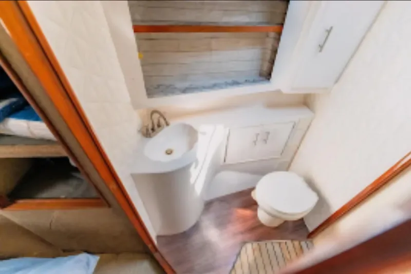Slide: The Image of Bathroom interior of 1988 Ocean Yachts 48 Super Sport, featuring sink and toilet. - 29