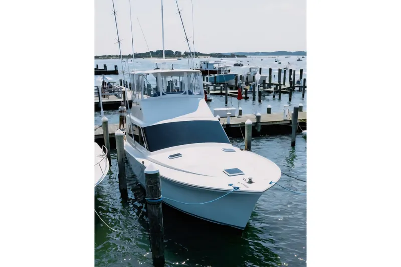 Slide: The Image of 1988 Ocean Yachts 48 Super Sport docked at marina, calm waters, clear sky. - 3