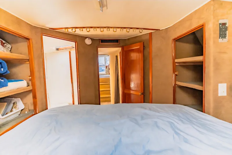 Slide: The Image of Interior cabin of 1988 Ocean Yachts 48 Super Sport with cozy bed and wooden shelves. - 30