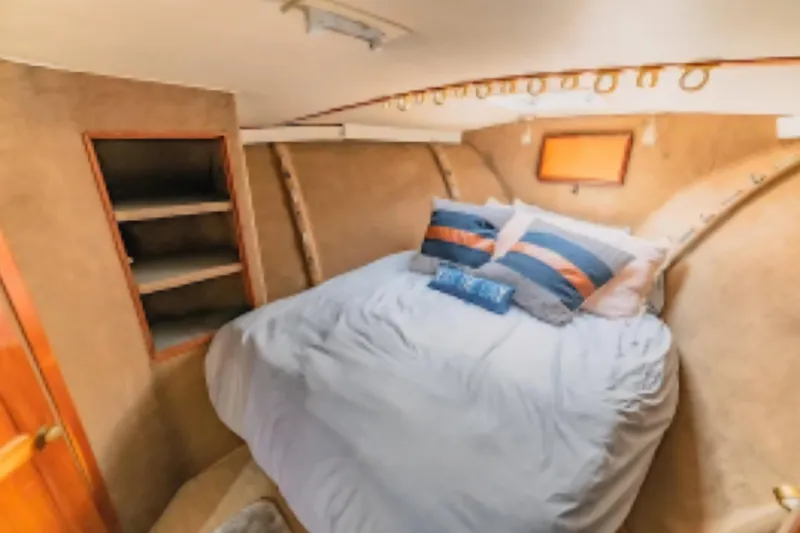 Slide: The Image of Cozy bedroom in 1988 Ocean Yachts 48 Super Sport with nautical decor. - 31