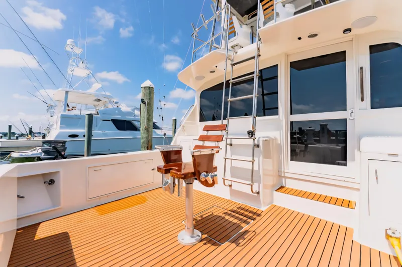 Slide: The Image of 1988 Ocean Yachts 48 Super Sport fishing deck with chair and ladder under blue sky. - 33