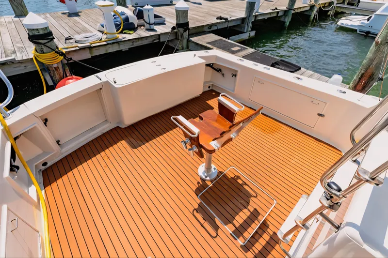 Slide: The Image of 1988 Ocean Yachts 48 Super Sport boat deck with wooden flooring and fishing chair. - 34