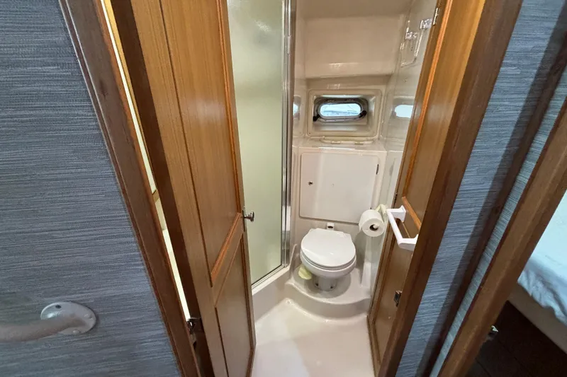 Slide: The Image of Cozy bedroom in 2000 Bayliner 3788 Command Bridge Motoryacht with portholes and overhead light. - 13