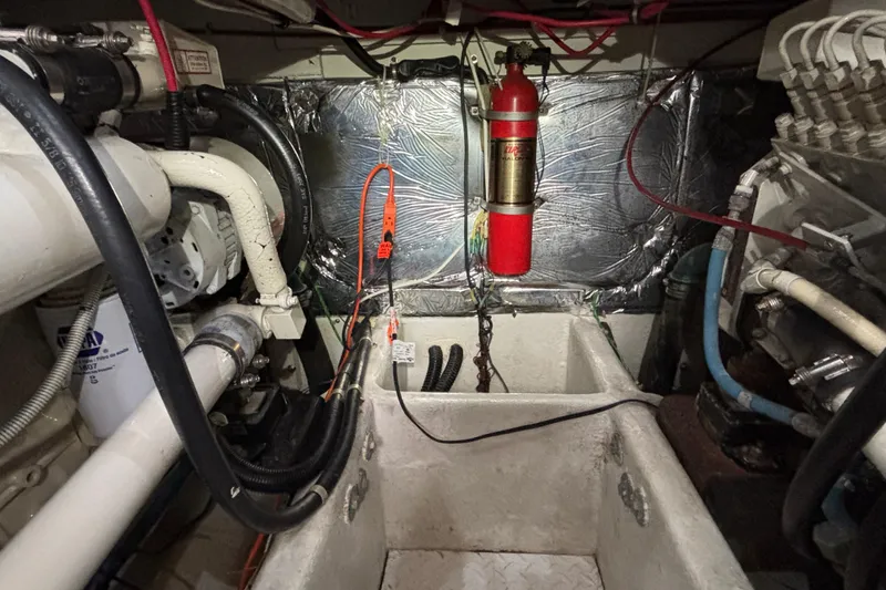 Slide: The Image of Engine room of 2000 Bayliner 3788 Command Bridge Motoryacht with fire extinguisher and wiring. - 25