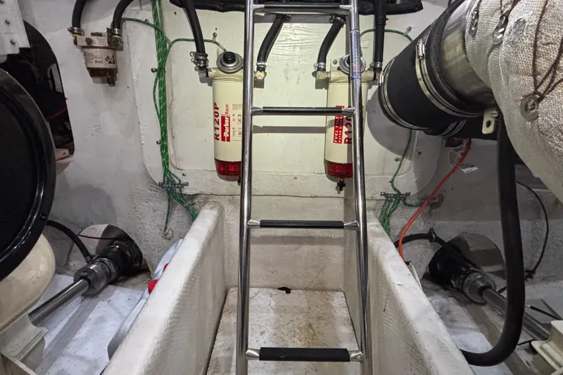 Slide: The Image of Engine room of 2000 Bayliner 3788 Command Bridge Motoryacht with ladder and fuel filters. - 26