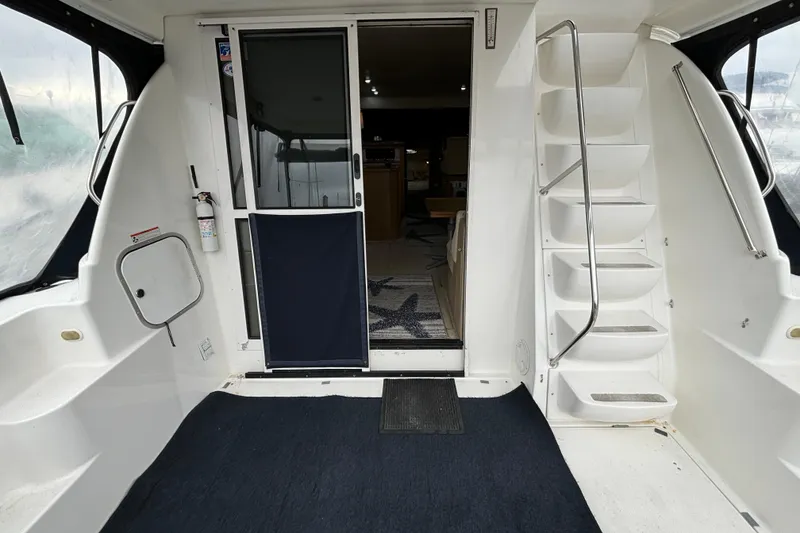 Slide: The Image of 2000 Bayliner 3788 Command Bridge Motoryacht deck with dinghy and Tohatsu outboard motor. - 4