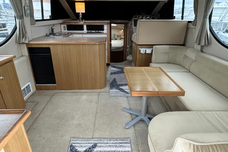 Slide: The Image of Interior of 2000 Bayliner 3788 Command Bridge Motoryacht with TV and wooden cabinets. - 7