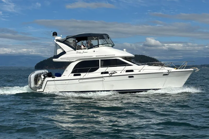 Slide: The Image of 2000 Bayliner 3788 Command Bridge Motoryacht cruising on open water. - 2
