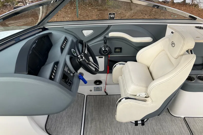 Slide: The Image of Interior of a 2021 Cobalt R7 Surf boat featuring a sleek dashboard and comfortable seating. - 21