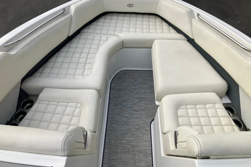 Slide: The Image of 2021 Cobalt R7 Surf boat interior with luxurious white seating and cup holders. - 23