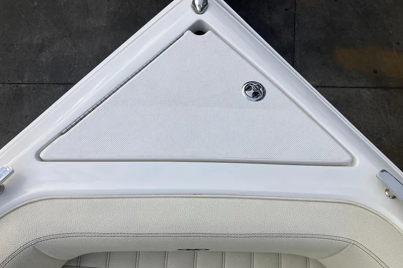 Slide: The Image of 2021 Cobalt R7 Surf boat interior with white upholstery and storage compartment. - 24
