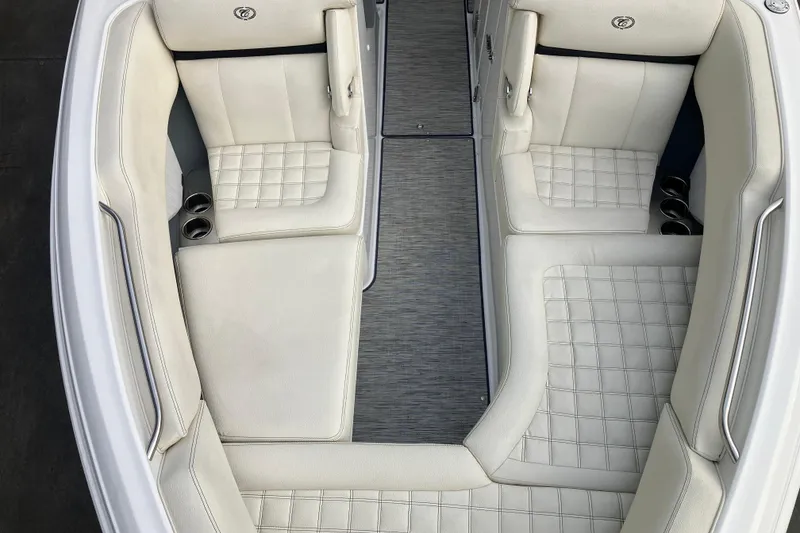 Slide: The Image of 2021 Cobalt R7 Surf boat interior with white leather seating and cup holders. - 25