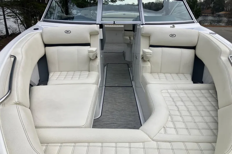 Slide: The Image of 2021 Cobalt R7 Surf boat interior with luxurious white seating and cup holders. - 26