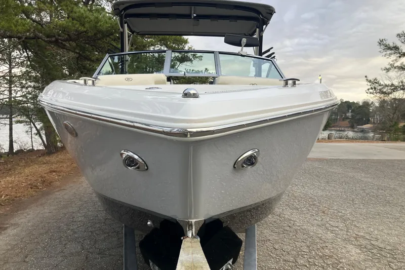 Slide: The Image of 2021 Cobalt R7 Surf boat on trailer, parked near a lake with trees. - 3