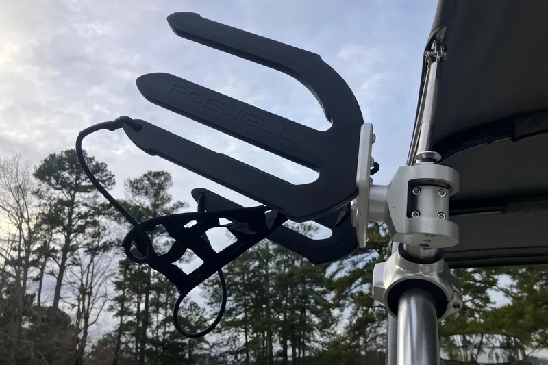 Slide: The Image of Wakeboard rack on 2021 Cobalt R7 Surf boat against a cloudy sky backdrop. - 31
