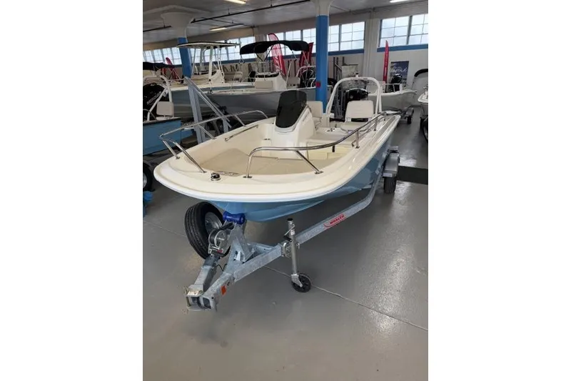 The Image of 2026 Boston Whaler 160 Super Sport boat on trailer in showroom. - 0