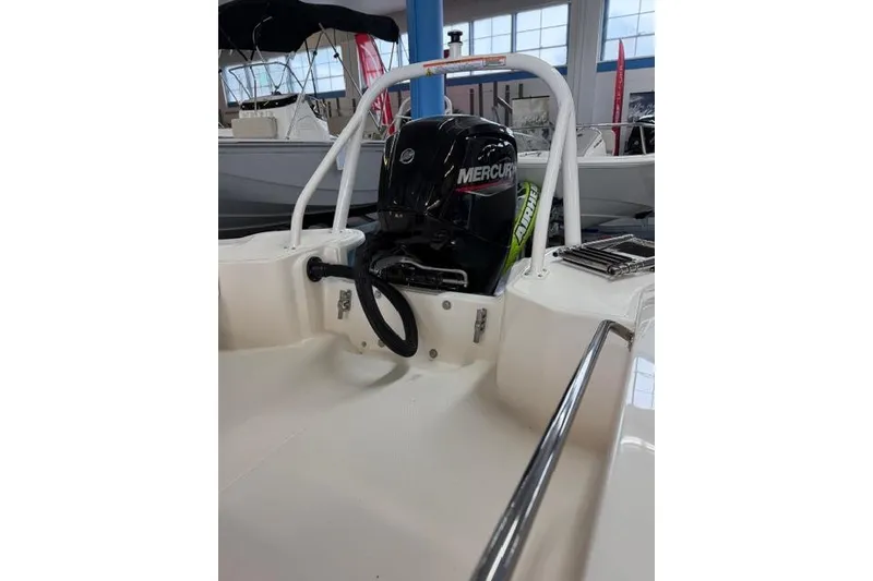 Slide: The Image of 2026 Boston Whaler 160 Super Sport with Mercury engine in showroom. - 10