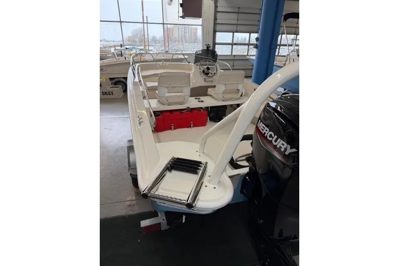 Slide: The Image of 2026 Boston Whaler 160 Super Sport boat with Mercury engine in showroom. - 11