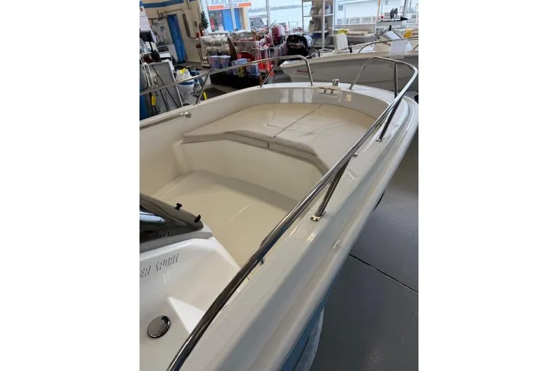 Slide: The Image of 2026 Boston Whaler 160 Super Sport boat interior with cushioned seating. - 12