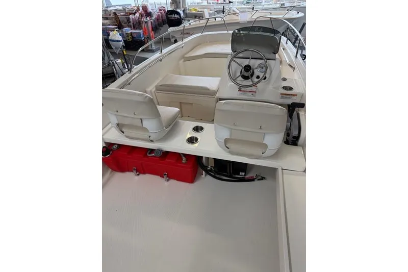 Slide: The Image of 2026 Boston Whaler 160 Super Sport boat interior with steering wheel and seating. - 13