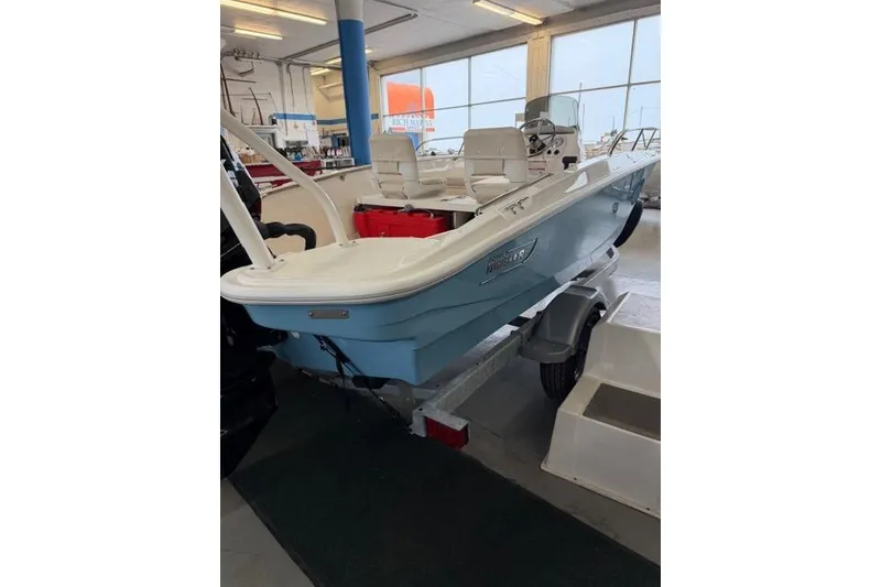 Slide: The Image of 2026 Boston Whaler 160 Super Sport boat in showroom, on trailer. - 14