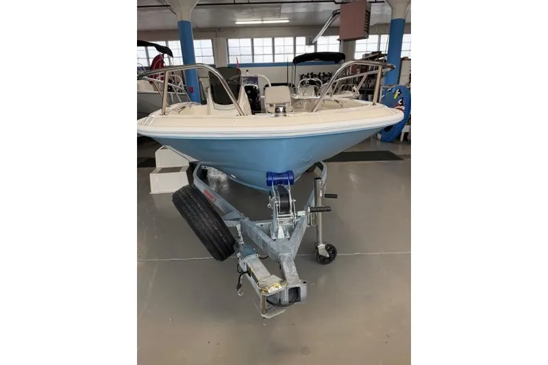 Slide: The Image of 2026 Boston Whaler 160 Super Sport boat on trailer in showroom. - 2