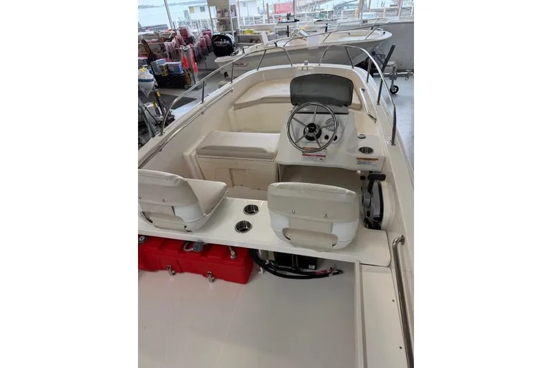 Slide: The Image of 2026 Boston Whaler 160 Super Sport interior with steering wheel and seating. - 5