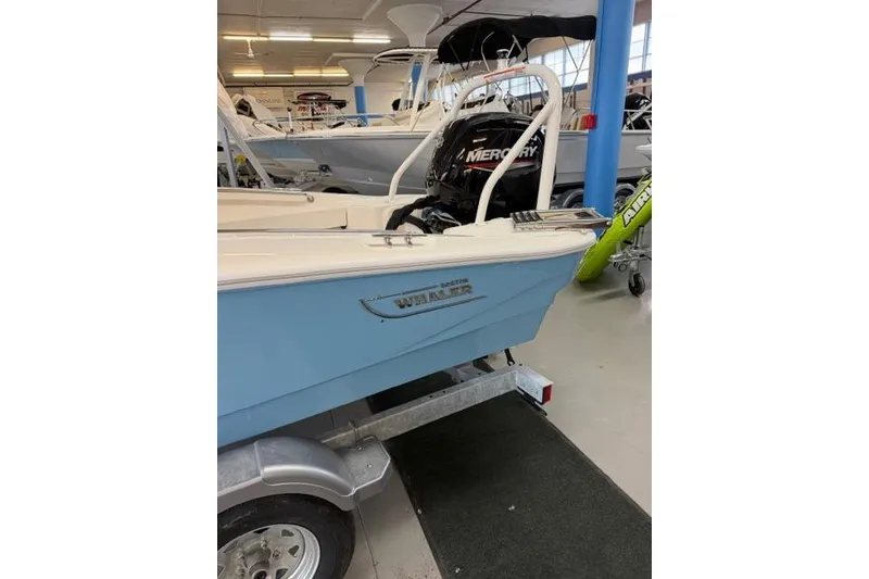 Slide: The Image of 2026 Boston Whaler 160 Super Sport boat on display in showroom. - 6