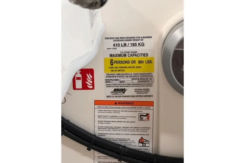 Slide: The Image of 2026 Boston Whaler 160 Super Sport capacity label, showing weight and passenger limits. - 8