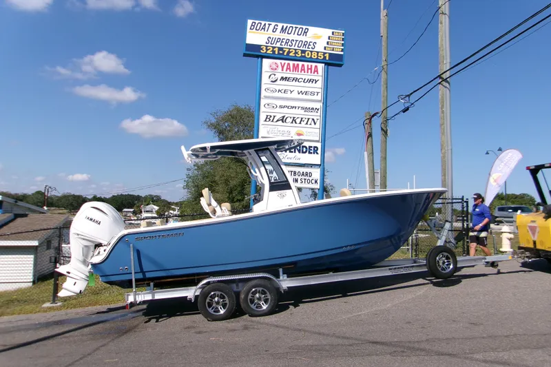 Slide: The Image of 2025 Sportsman Heritage 231 Center Console boat on trailer at dealership. - 1