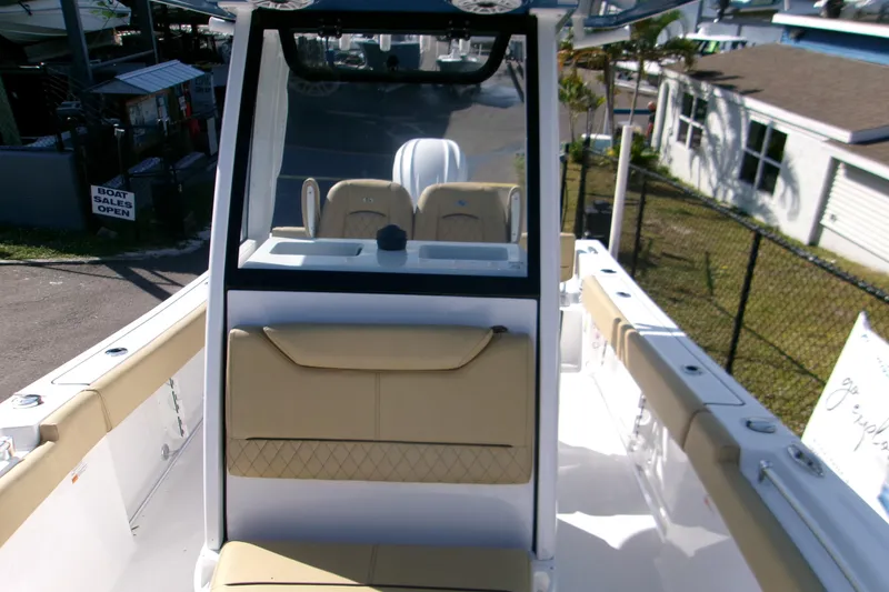 Slide: The Image of 2025 Sportsman Heritage 231 Center Console boat interior with beige seating and console. - 20