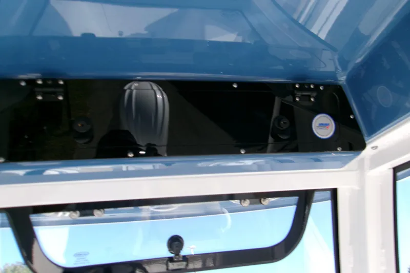 Slide: The Image of 2025 Sportsman Heritage 231 Center Console interior view with blue accents. - 23