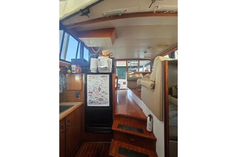 Slide: The Image of Interior of 1989 Bayliner 3888 Motoryacht with kitchen and seating area. - 18
