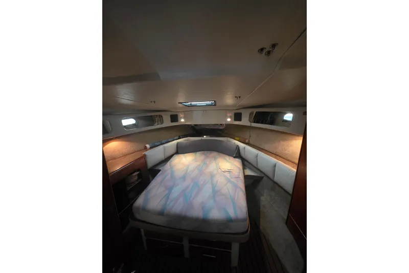 Slide: The Image of 1989 Bayliner 3888 Motoryacht interior cabin with bed and ambient lighting. - 19