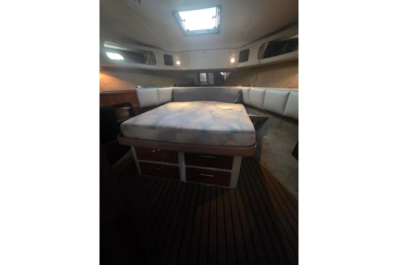 Slide: The Image of 1989 Bayliner 3888 Motoryacht cabin interior with bed and storage drawers. - 21