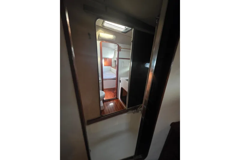 Slide: The Image of 1989 Bayliner 3888 Motoryacht interior cabin with bed and bathroom view. - 26