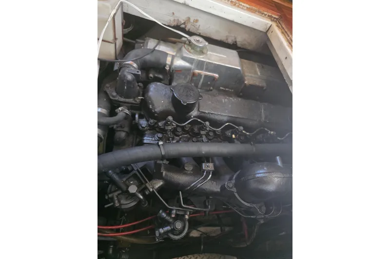Slide: The Image of Engine of 1989 Bayliner 3888 Motoryacht, showcasing mechanical components and hoses. - 29