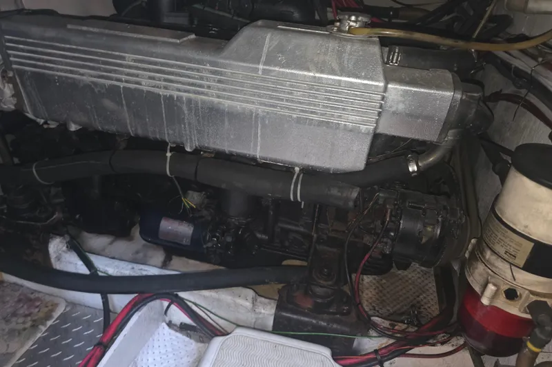 Slide: The Image of Engine compartment of a 1989 Bayliner 3888 Motoryacht, showing mechanical components and wiring. - 31