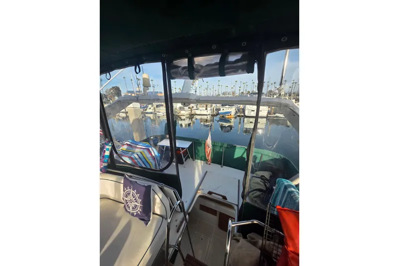 Slide: The Image of 1989 Bayliner 3888 Motoryacht interior view with marina backdrop. - 33