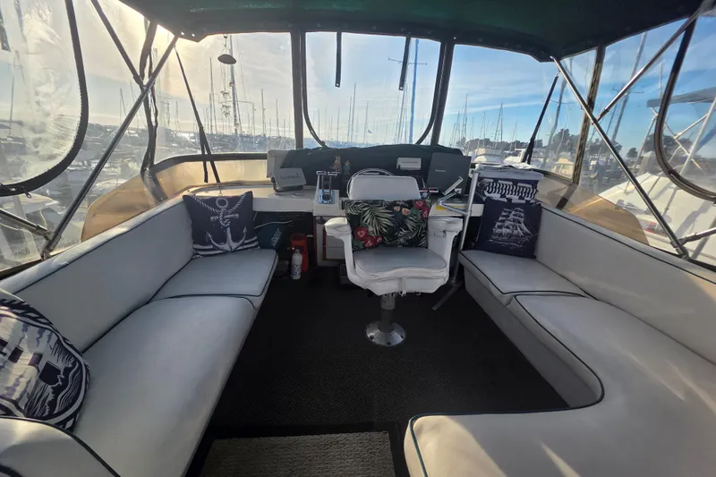 Slide: The Image of 1989 Bayliner 3888 Motoryacht interior with seating, helm, and nautical decor. - 34