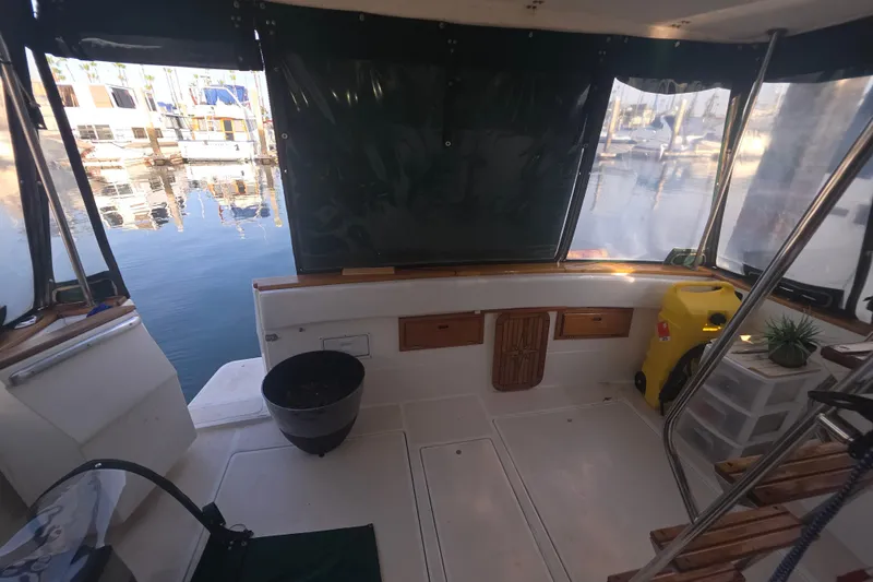 Slide: The Image of 1989 Bayliner 3888 Motoryacht interior with marina view, featuring seating and storage. - 37