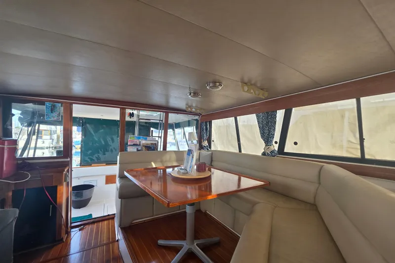 Slide: The Image of Interior of 1989 Bayliner 3888 Motoryacht with dining area and large windows. - 5