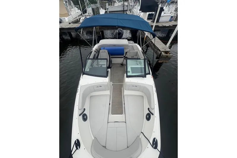 Slide: The Image of 2022 Sea Ray 19 SPX OB boat with blue canopy docked at marina. - 11