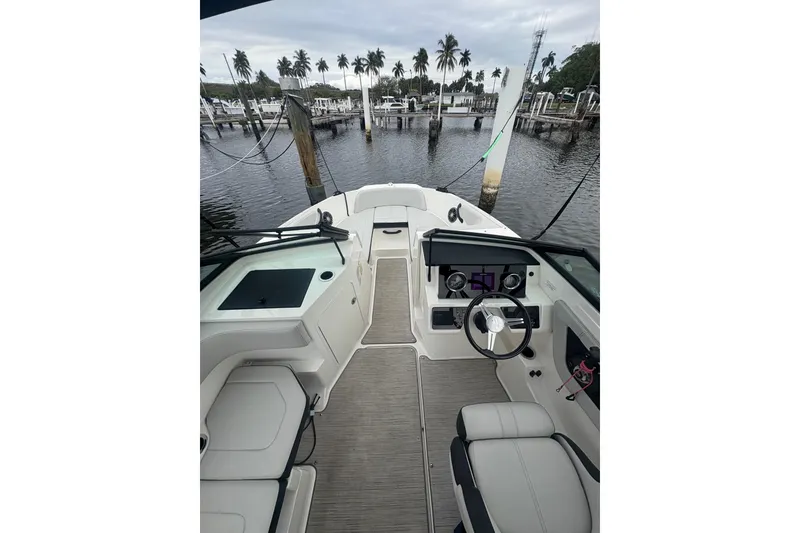 Slide: The Image of 2022 Sea Ray 19 SPX OB boat interior with steering wheel, docked at marina. - 16