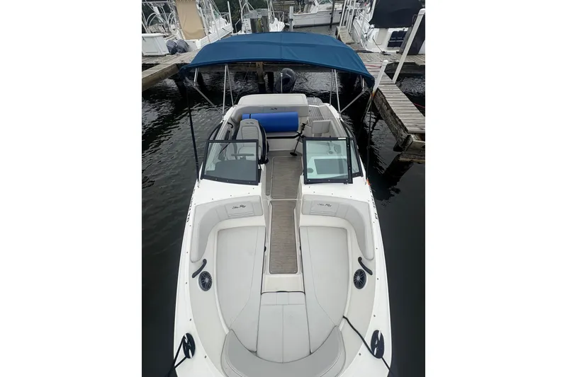 Slide: The Image of 2022 Sea Ray 19 SPX OB boat with blue canopy docked at marina. - 17