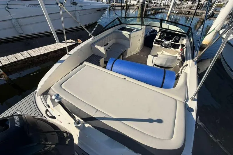 Slide: The Image of 2022 Sea Ray 19 SPX OB boat docked, featuring spacious seating and modern design. - 23