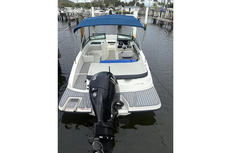 Slide: The Image of 2022 Sea Ray 19 SPX OB boat with blue canopy, docked at marina. - 4